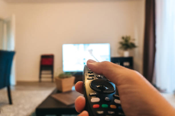 Man choosing channel on tv. POV concepts.